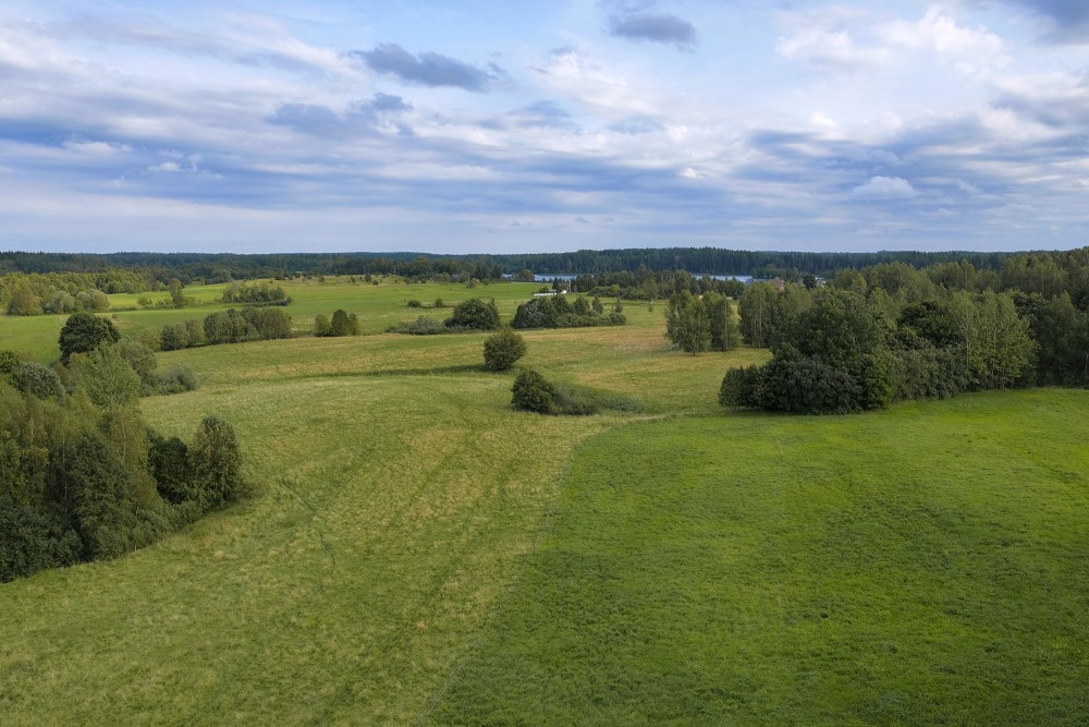 View from Siberija observation tower over wide meadows and a distant lake