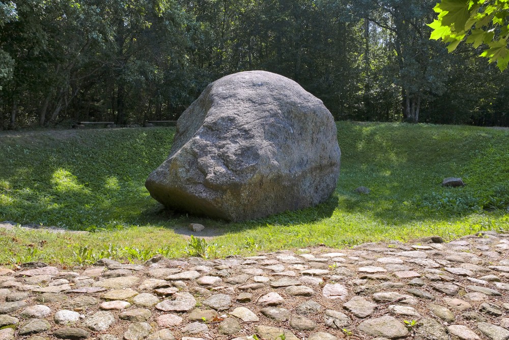 Šilalės Kūlis boulder in a forest hollow with a cobblestone path in the foreground
