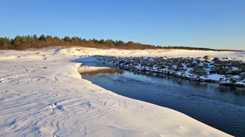 Winter view of the Pape canal mouth and stone pier