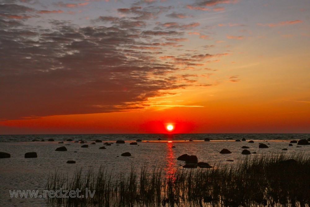 Sunrise at stony shore in Mersrags, Latvia