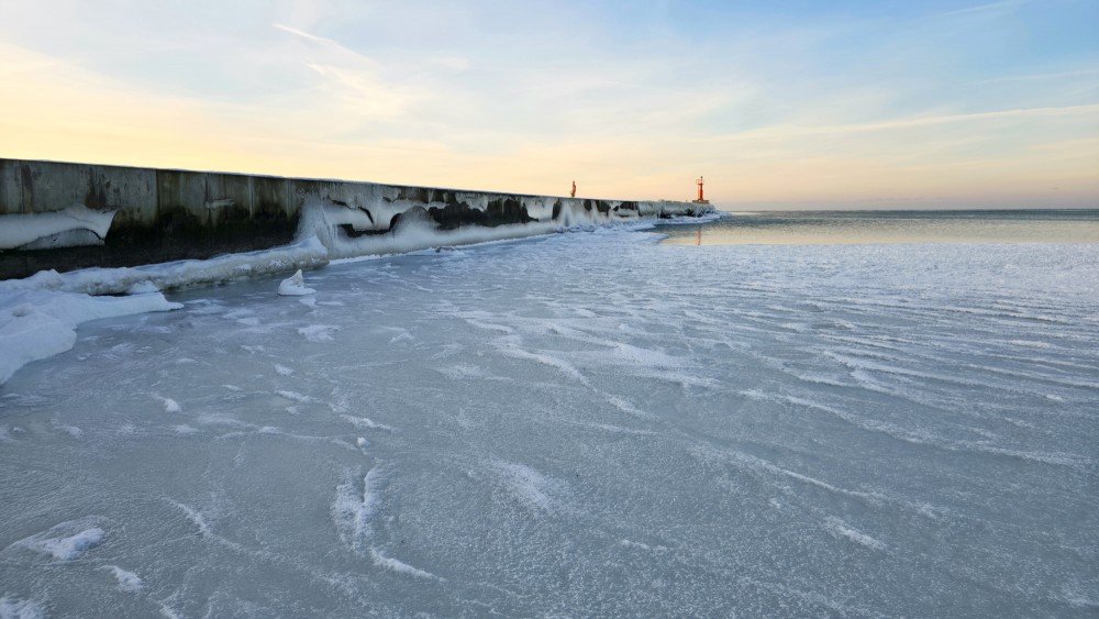 Icy Pavilosta pier and frozen Baltic Sea