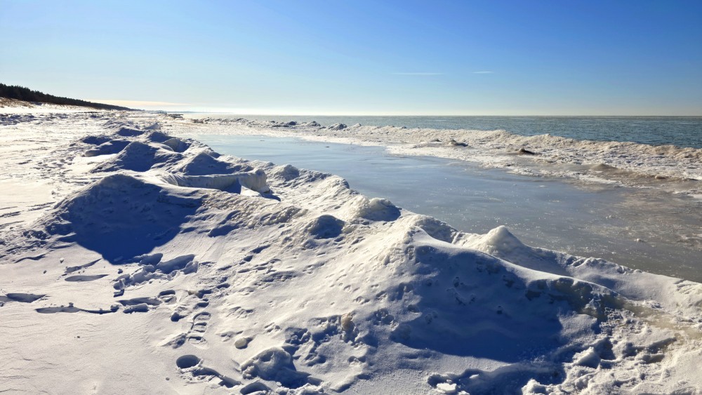 Sunlit ice ridges and frozen Baltic Sea coast