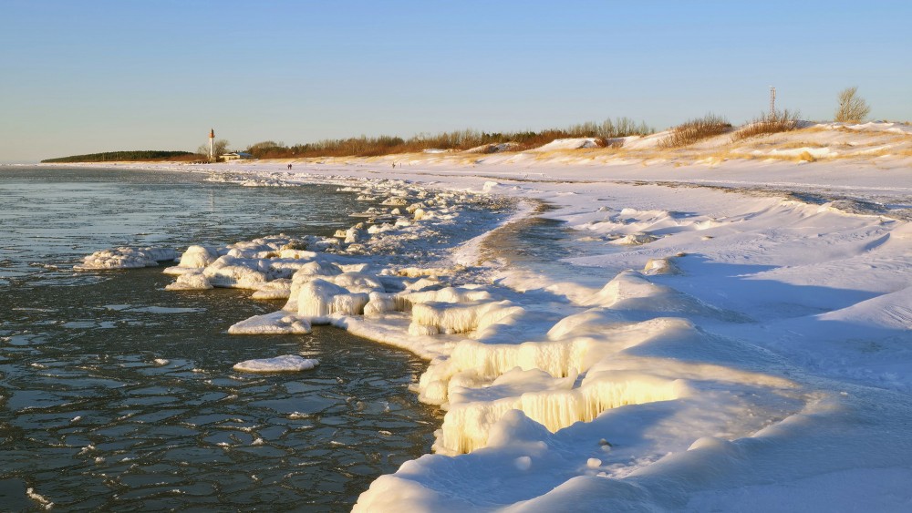 Ice sculptures and frosted shores on the Pape coast at sunset