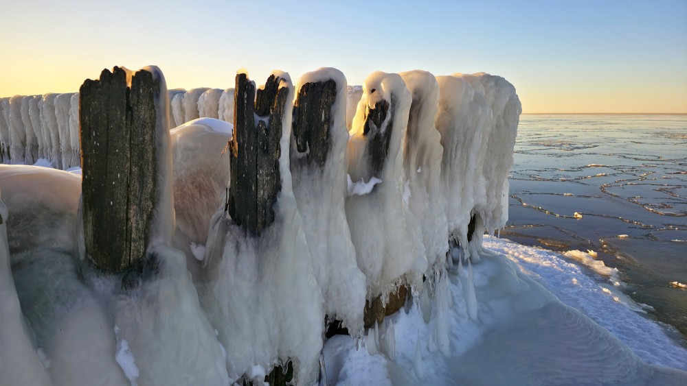 Sunset light on frozen Pape canal piles