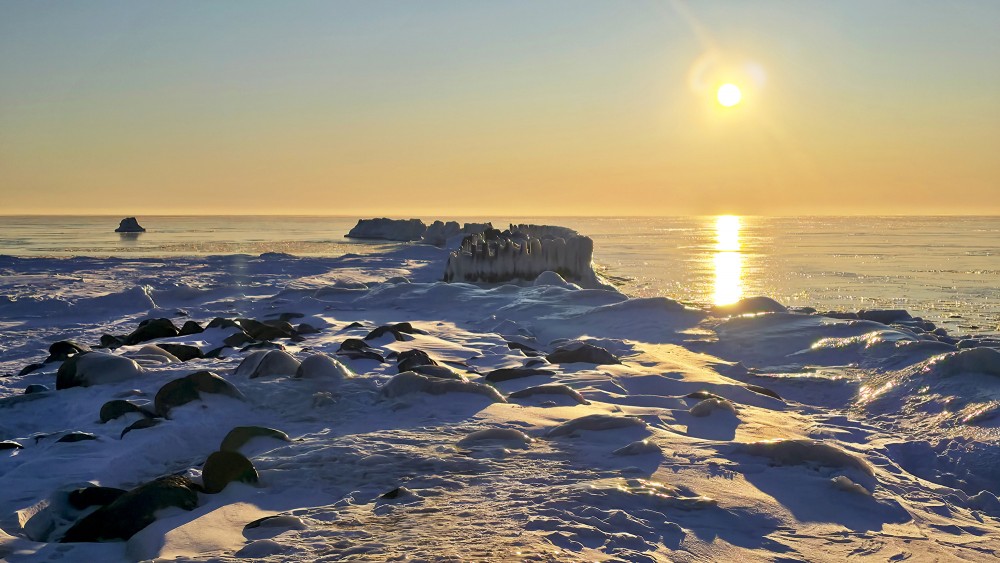 Winter sunset over the snowy coast and Pape groynes