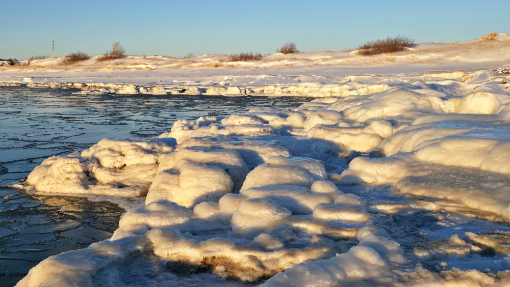 Frozen Baltic Sea coast and ice ridges at Pape beach