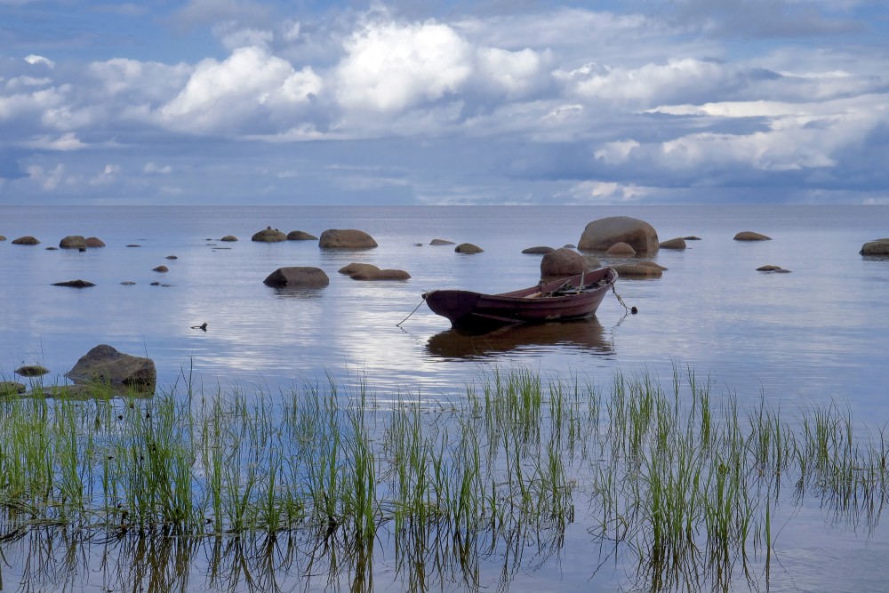 Akmeņainā jūrmala un laiva