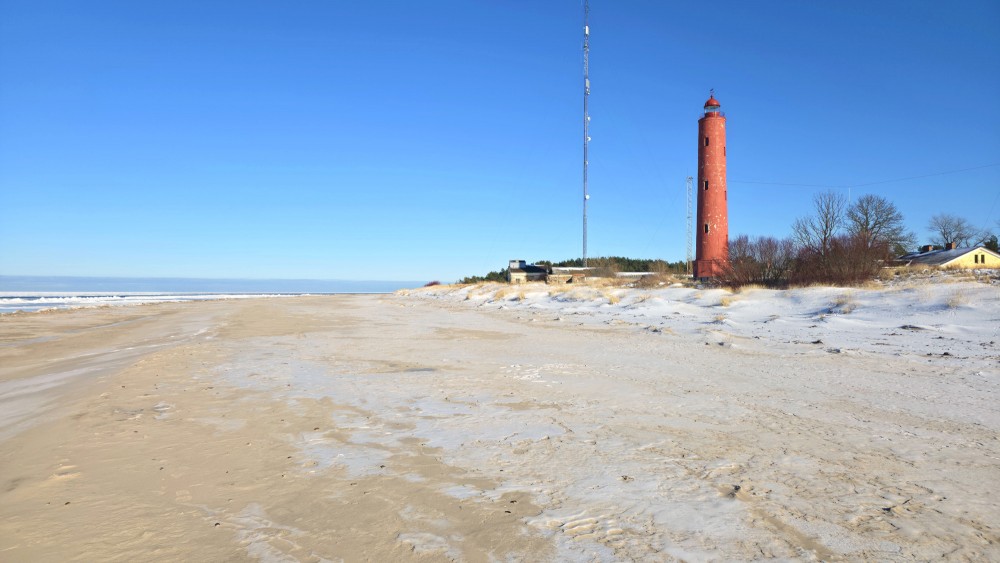 Akmensrags Lighthouse in winter by the Baltic Sea coast