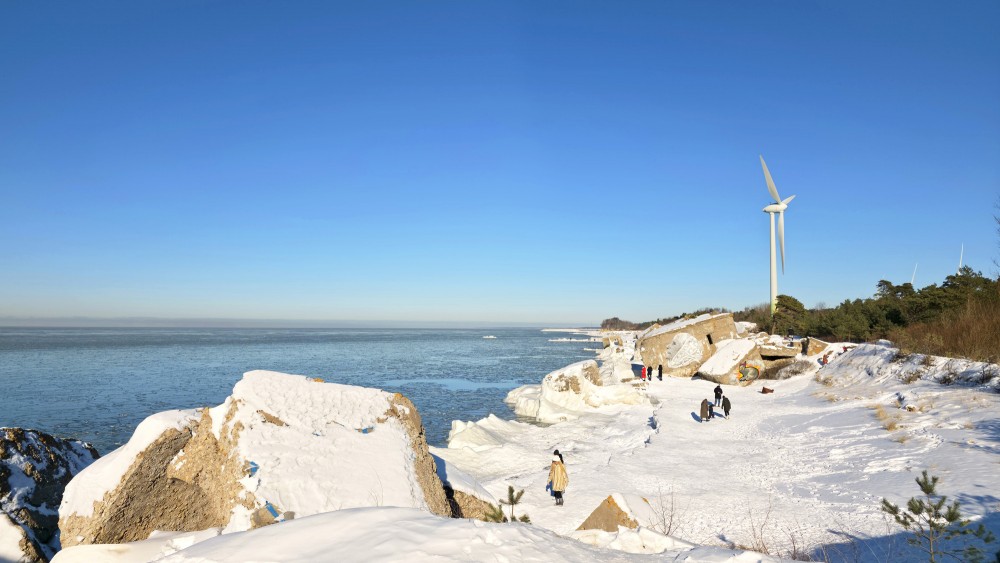 Liepaja northern forts in winter with a wind turbine and visitors