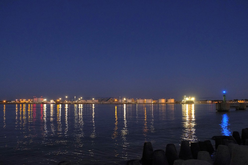 Evening panorama of Ventspils port with light reflections on the Venta River